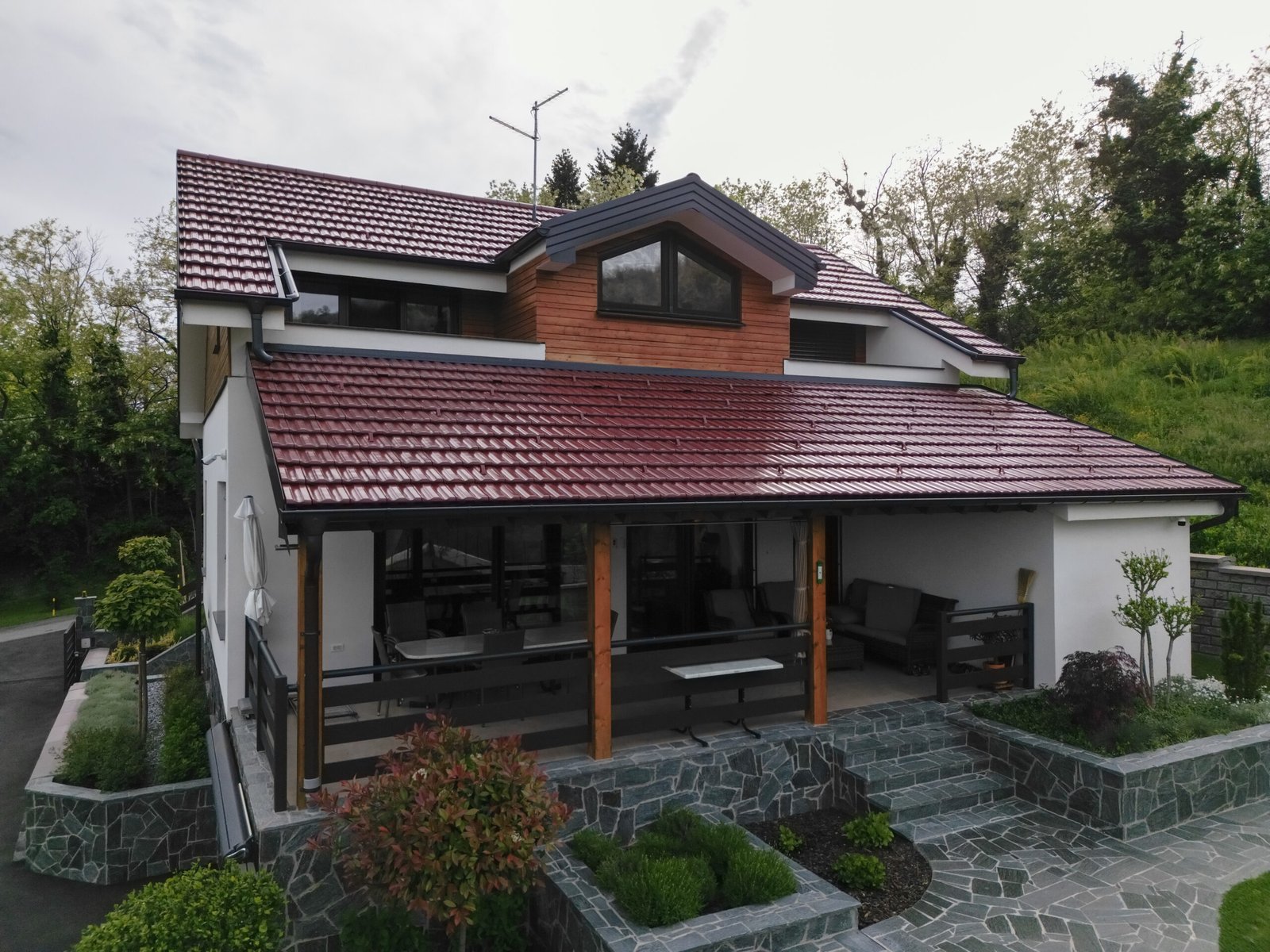 Two-storey PARTAS family house with a red tiled roof and landscaped garden