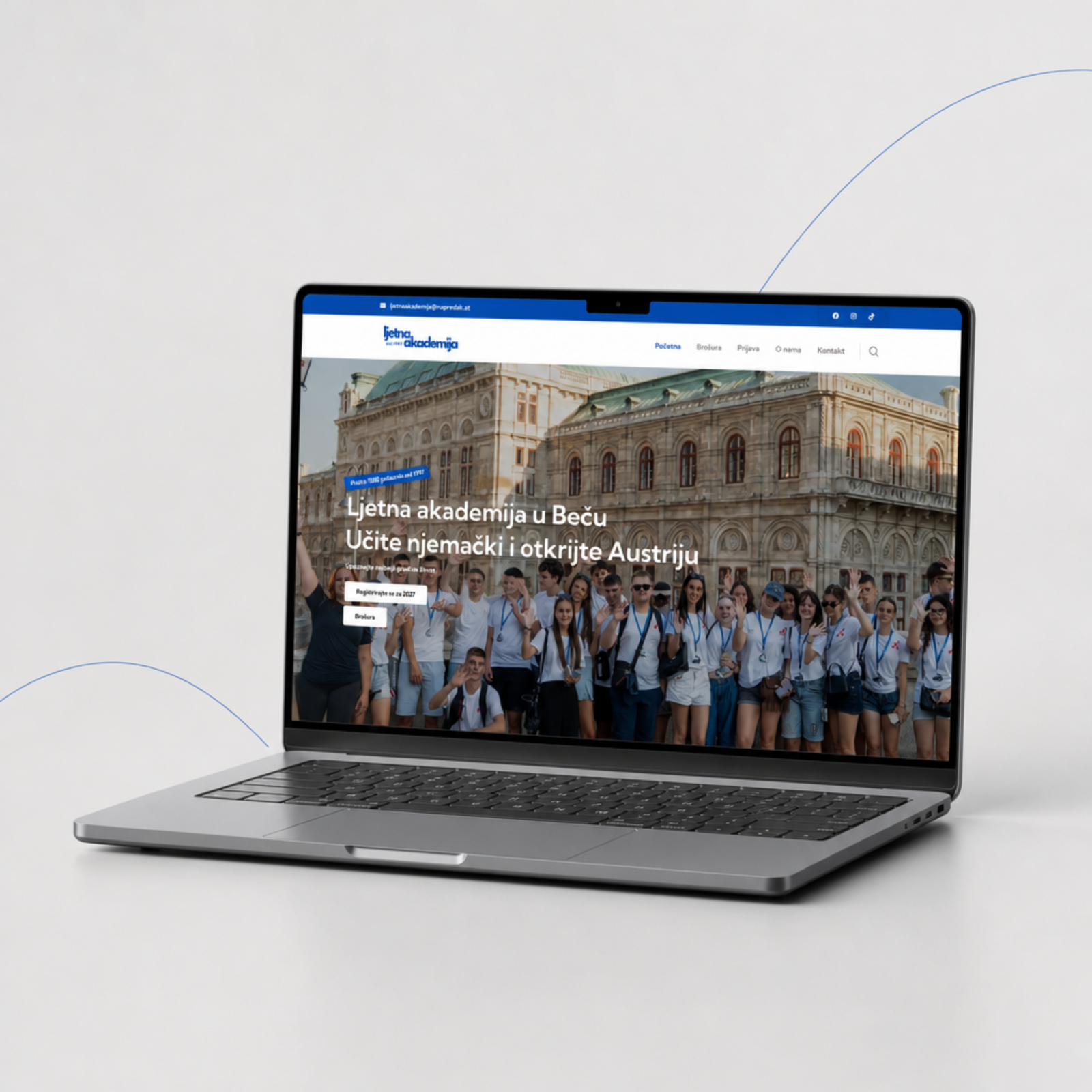 Laptop showing the Ljetna akademija website with a group photo of participants