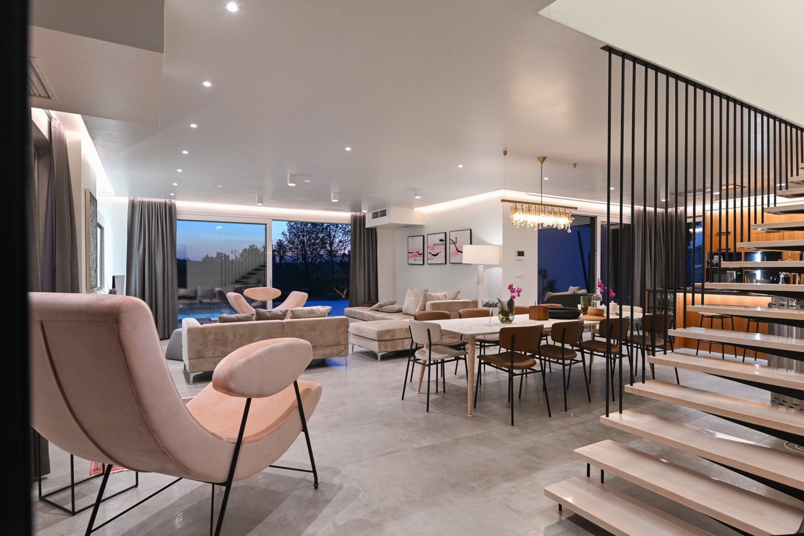 Bright open-plan living and dining room in a PARTAS house with a floating staircase