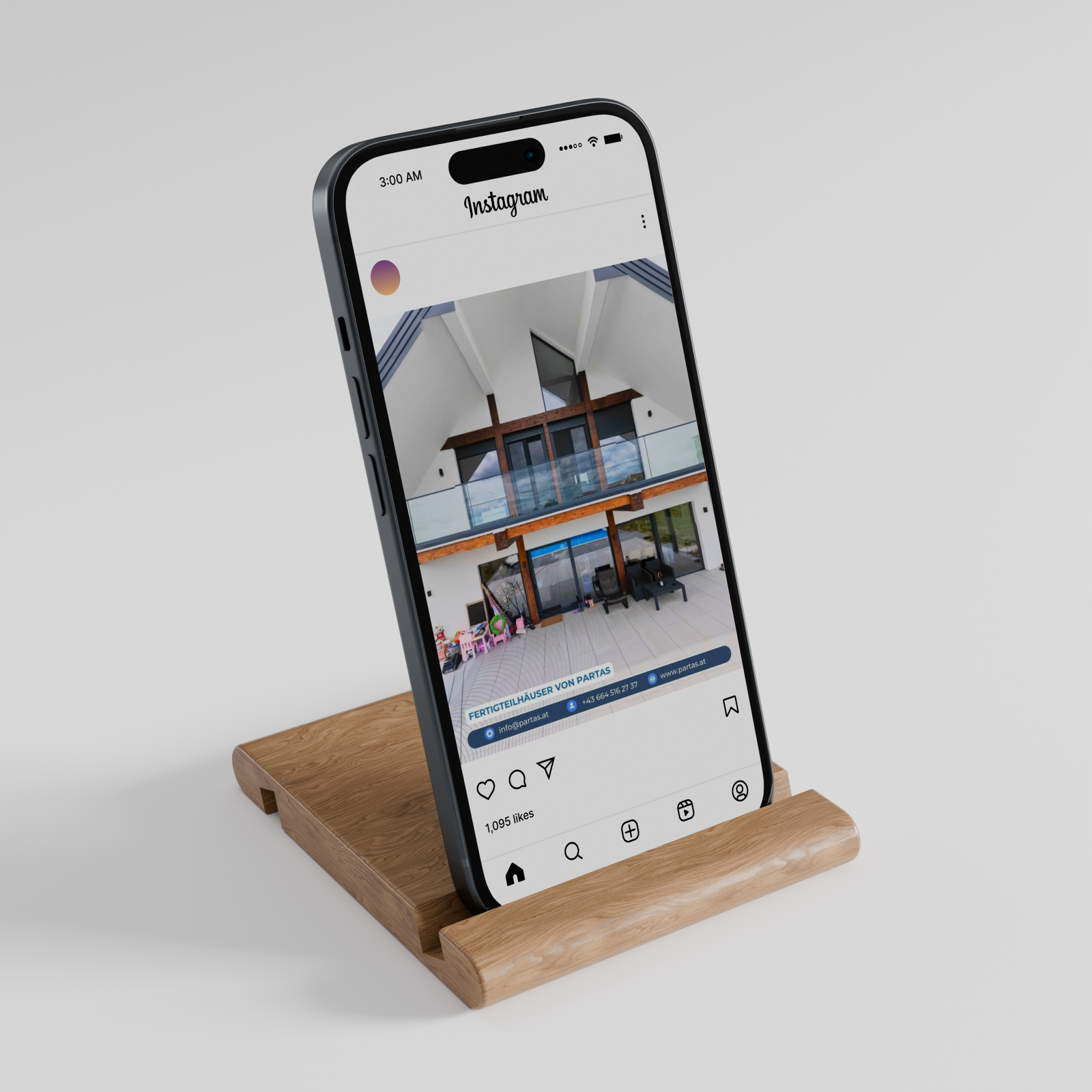 Smartphone on a wooden stand showing the PARTAS social media profile