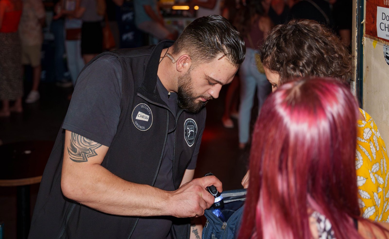 Safe Solutions staff member checking a guest's bag at entry